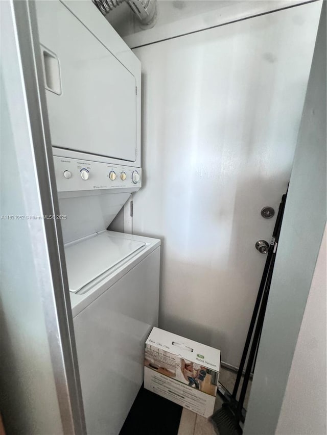 washroom featuring stacked washer and clothes dryer