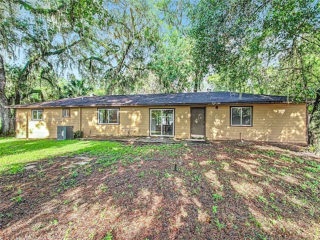 single story home with a front lawn and central AC unit