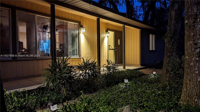 exterior entry at night with a patio area