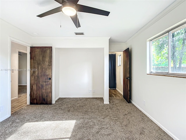 unfurnished bedroom with carpet floors, ceiling fan, and ornamental molding