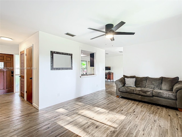 living room featuring ceiling fan and light wood-type flooring