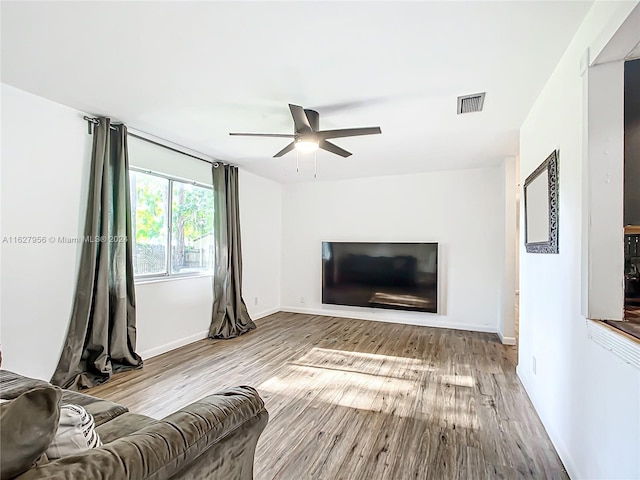 living room featuring light wood-type flooring and ceiling fan