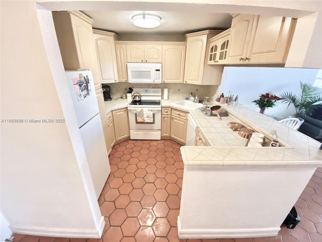 7928 W Dr Unit 303, North Bay Village, FL 33141 - kitchen with white appliances, a peninsula, tile counters, glass insert cabinets, and tile patterned floors