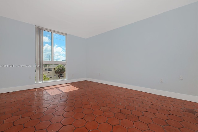 spare room featuring baseboards