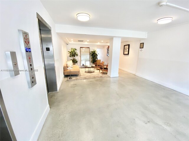 hall with concrete flooring