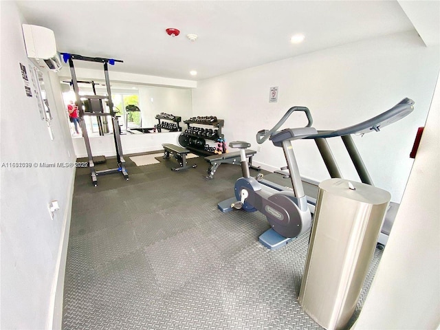 workout room featuring recessed lighting, baseboards, and a wall mounted AC