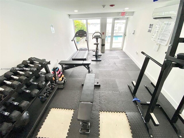 gym featuring an AC wall unit