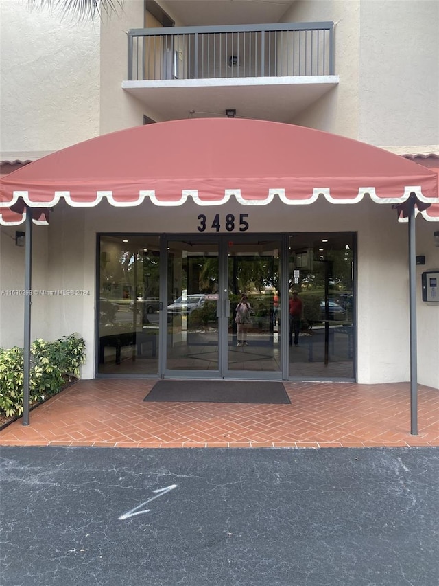 entrance to property with a balcony