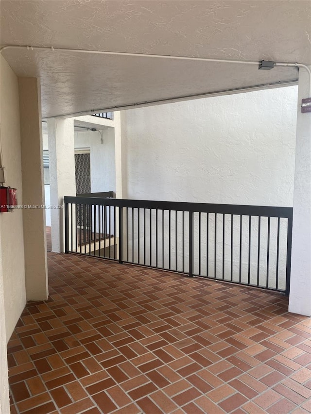 hall featuring brick floor