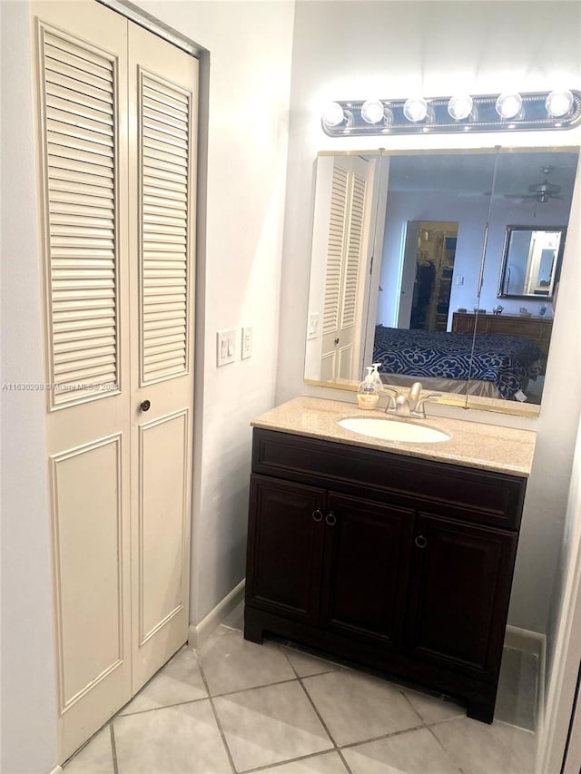 bathroom featuring a closet, tile patterned flooring, and vanity