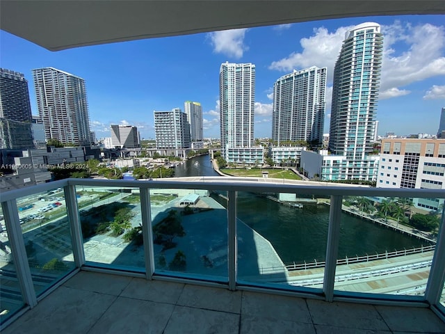 balcony featuring a water view and a view of city