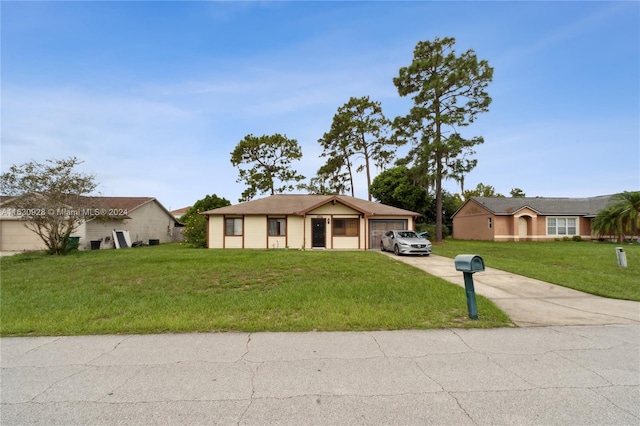 ranch-style house featuring a garage and a front yard