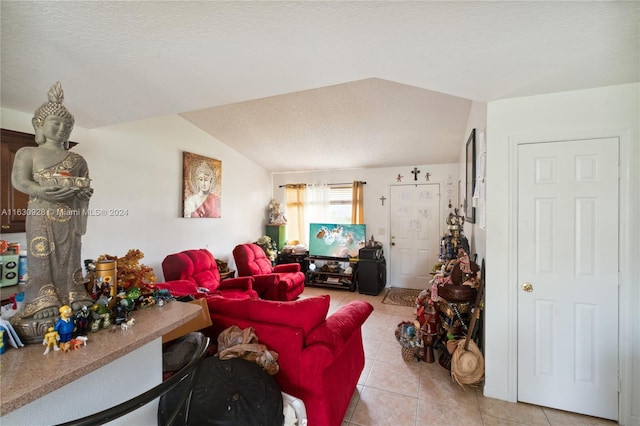 living area featuring lofted ceiling, light tile patterned flooring, and a textured ceiling