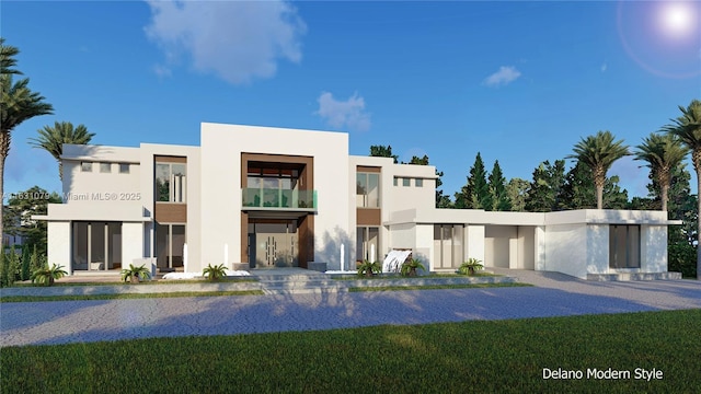 view of front facade with a front lawn and stucco siding