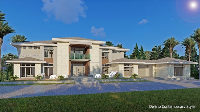 view of front of home featuring a garage, a front lawn, decorative driveway, and stucco siding