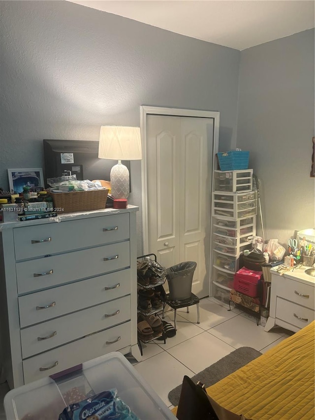 bedroom featuring a closet and light tile patterned floors