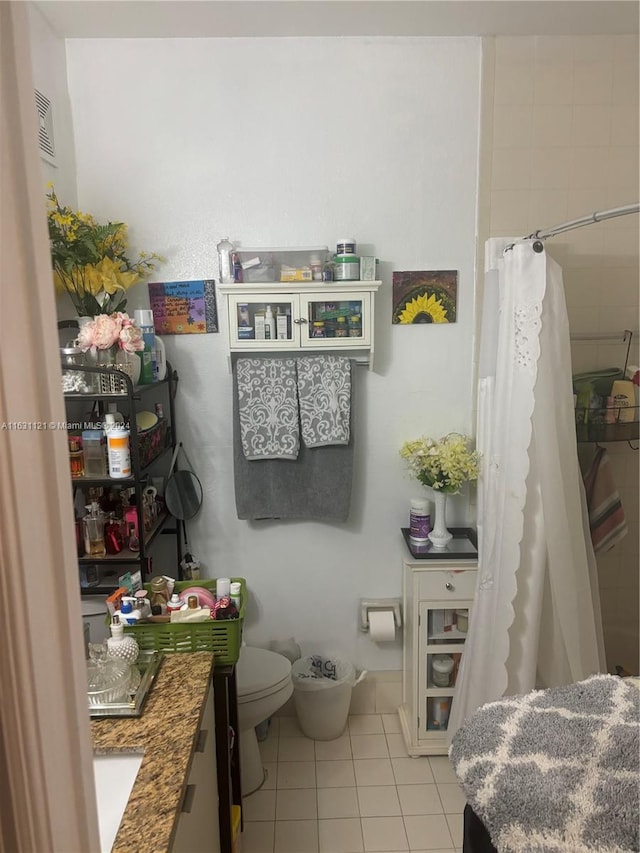 bathroom with tile patterned floors, toilet, and vanity