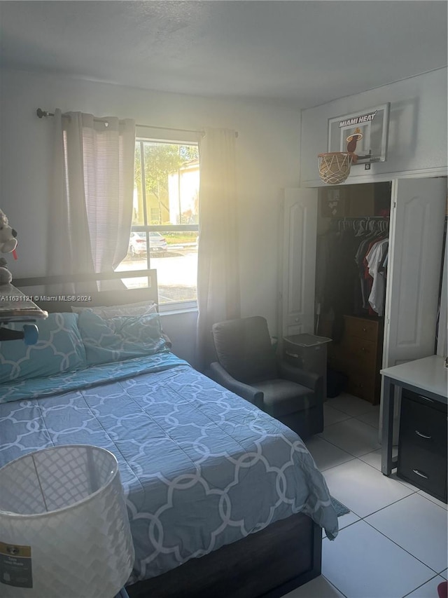 tiled bedroom with a closet