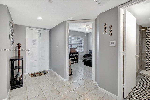 entryway featuring ceiling fan and light tile patterned floors