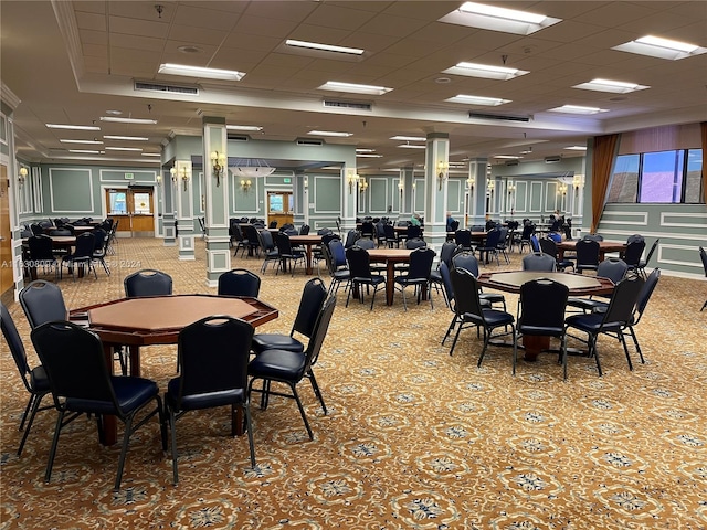 carpeted dining space featuring a drop ceiling