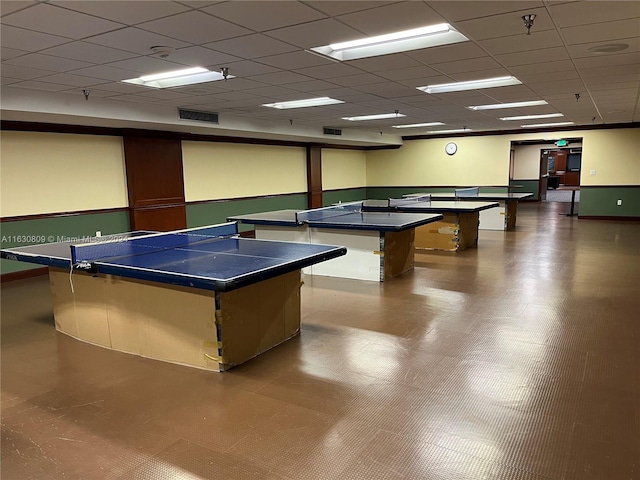 recreation room featuring a drop ceiling