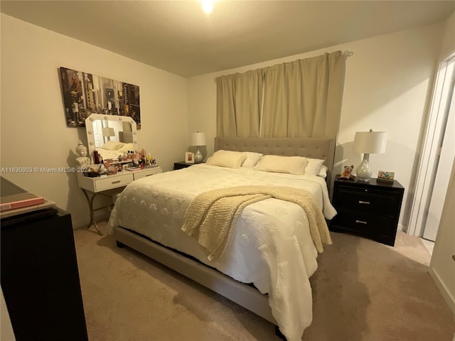 bedroom featuring light carpet