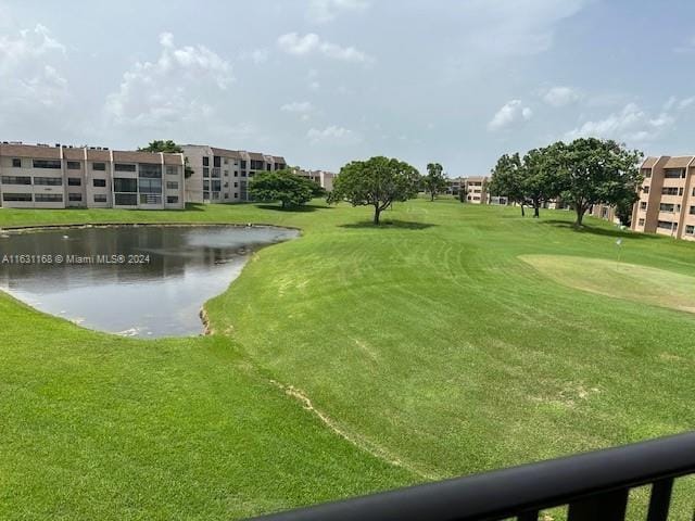 view of community with a yard and a water view