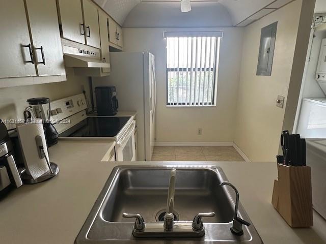 kitchen with electric panel, sink, washer / clothes dryer, white electric range oven, and light tile patterned floors