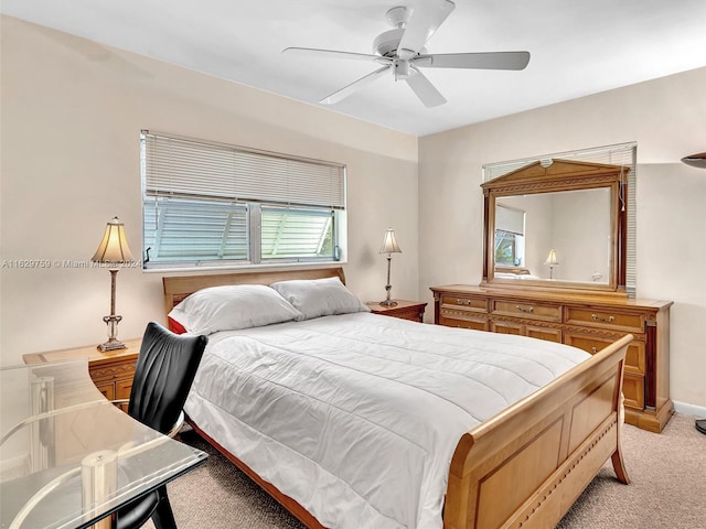 bedroom featuring multiple windows, ceiling fan, and light colored carpet