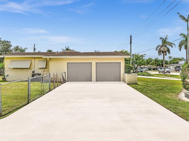 ranch-style house featuring a garage and a front lawn