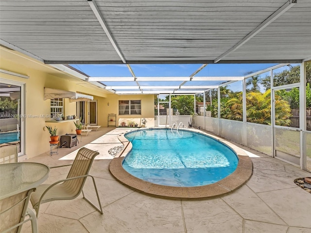 view of pool with a lanai and a patio