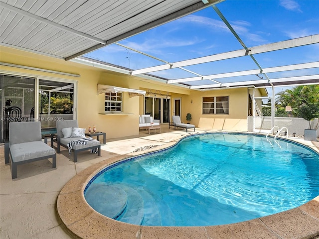 view of swimming pool featuring glass enclosure, a patio area, and an outdoor living space