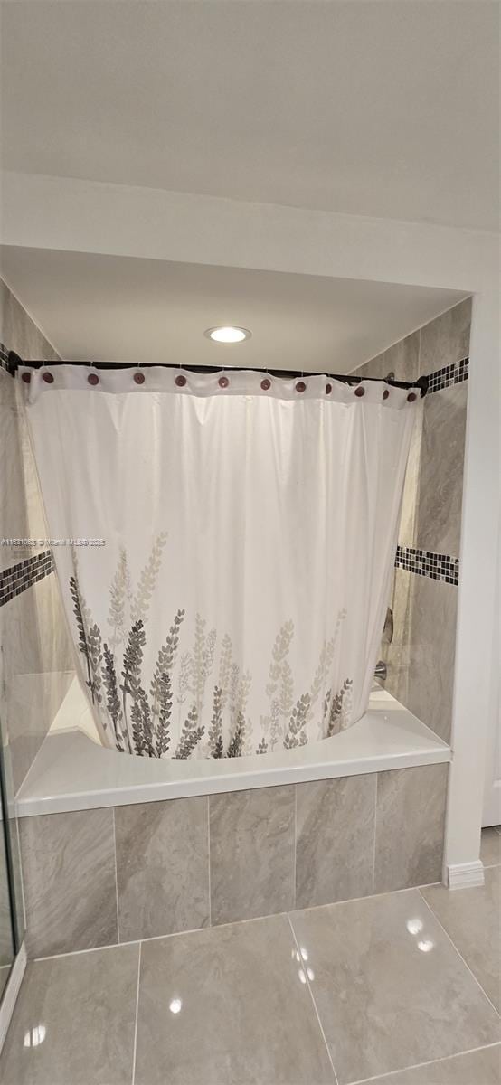 bathroom with shower / bath combination with curtain