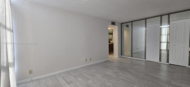 spare room with light wood-type flooring