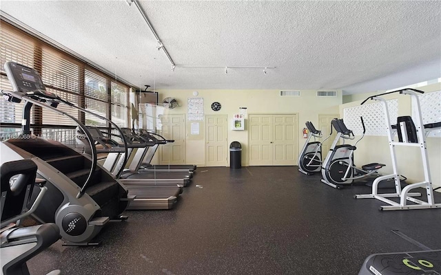 workout area featuring a textured ceiling