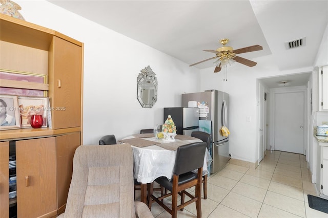 tiled dining area featuring ceiling fan