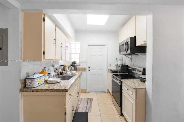 2901 SW 21st St, Miami, FL 33145 - kitchen featuring appliances with stainless steel finishes, a sink, decorative backsplash, and light tile patterned floors