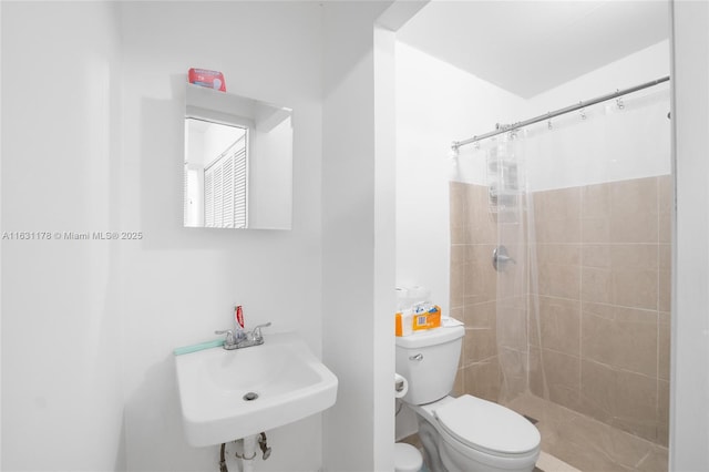 bathroom with sink, toilet, and a shower with curtain