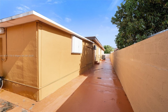 view of side of property featuring central air condition unit