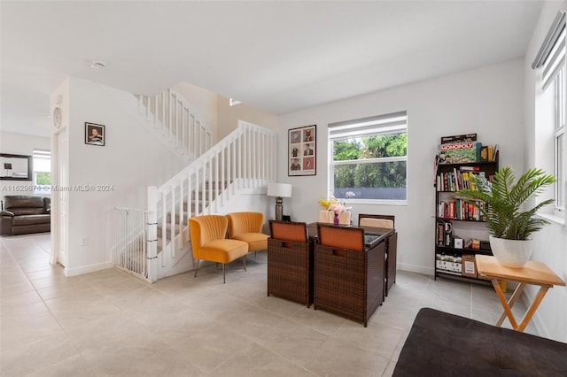 living area with light tile patterned flooring and a wealth of natural light