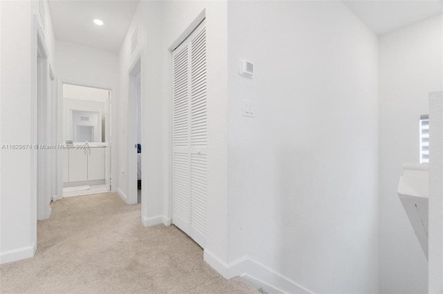 corridor with light colored carpet