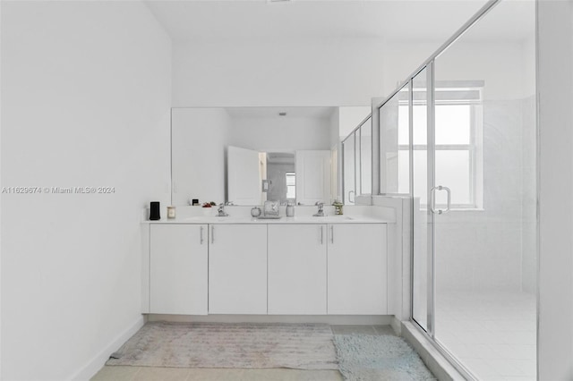 bathroom with a shower with shower door, tile patterned floors, and a wealth of natural light