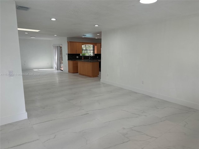 unfurnished living room with sink