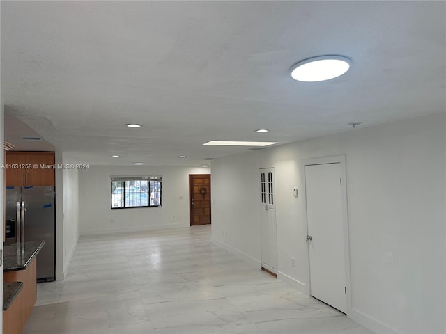 324 E 34th St, Hialeah, FL 33013 - hallway featuring light marble finish floors and recessed lighting