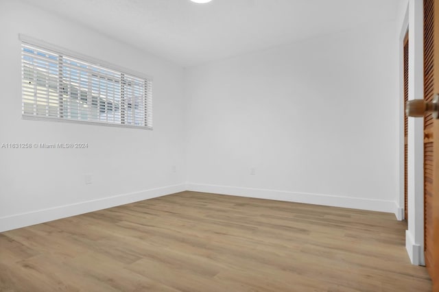 324 E 34th St, Hialeah, FL 33013 - unfurnished bedroom featuring light wood-style floors and a closet
