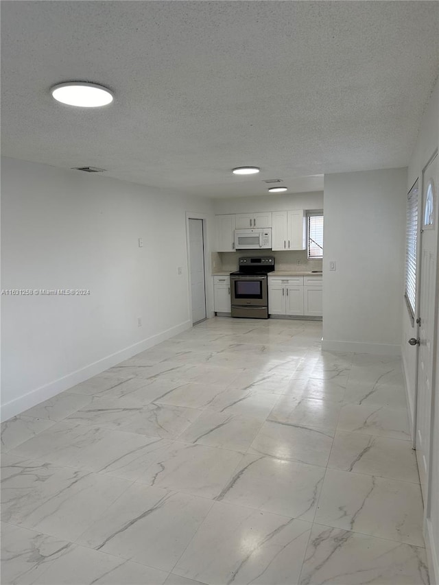 unfurnished living room with a textured ceiling