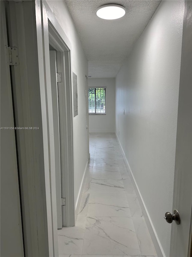 corridor with a textured ceiling