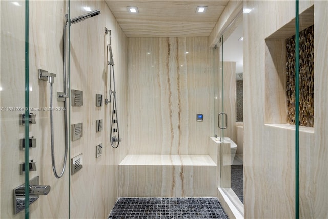 bathroom with a shower with door