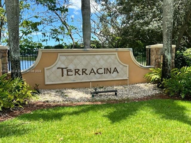 community / neighborhood sign with a lawn