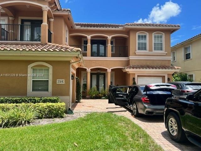 view of front facade with a balcony and a garage